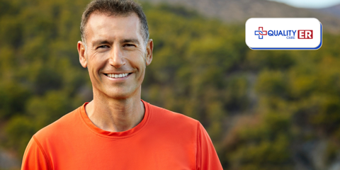 older man in orange shirt smiling outdoors